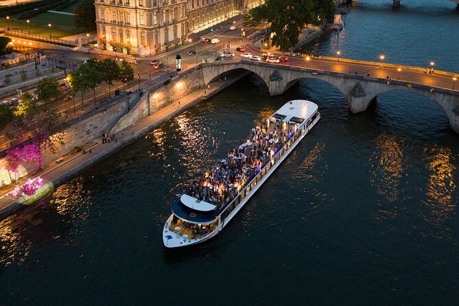 Illuminated Eiffel Tower seen from a Seine River cruise at night