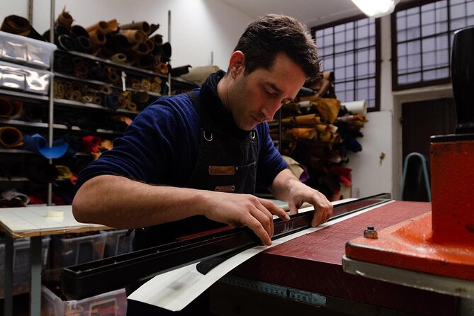 A person working with leather in a Florentine leather crafting workshop