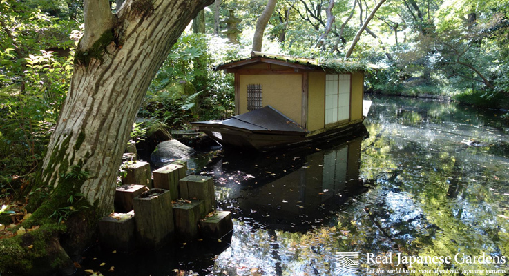 A tranquil scene of the Japanese garden at the Nezu Museum, featuring a pond and lush greenery.