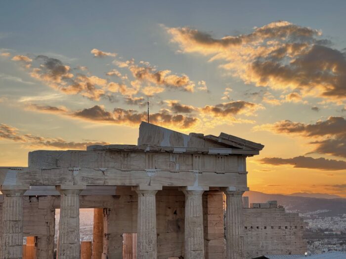 Athens cityscape at sunset with the Acropolis in view.