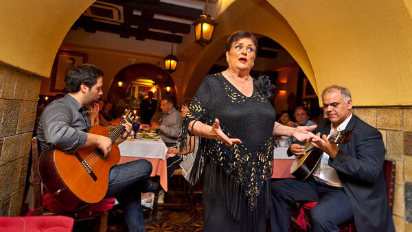 Fado singer performing in a traditional Lisbon restaurant