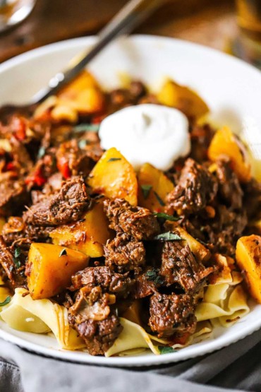 A bowl of traditional Hungarian goulash with paprika and vegetables.