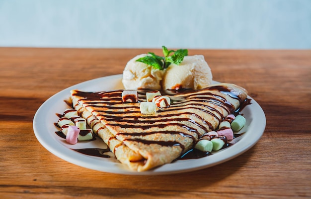 A close-up shot of a mouth-watering sweet crêpe topped with melted Nutella, a popular Parisian treat.