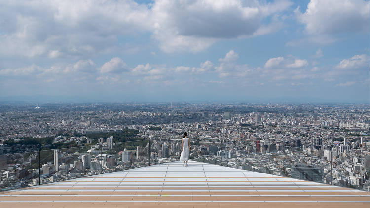 A breathtaking panoramic view of Tokyo from the Shibuya Sky observation deck at sunset.