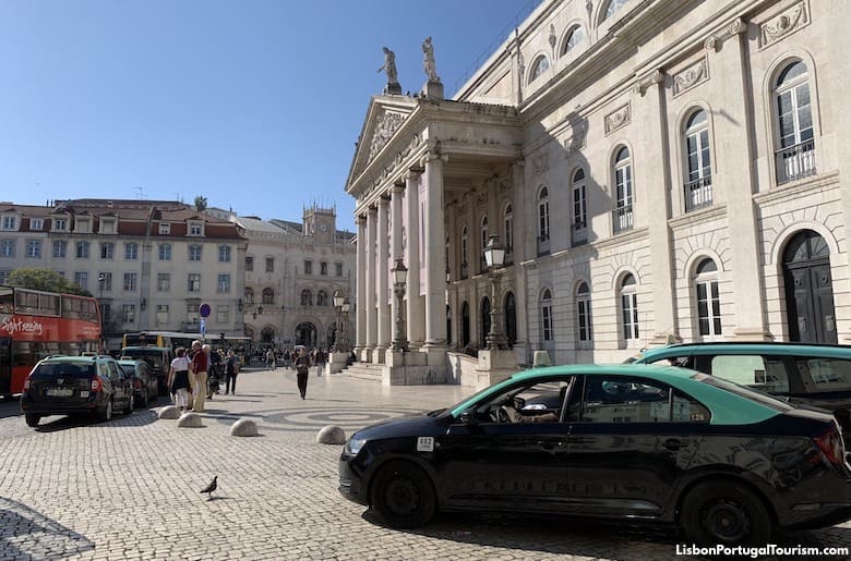 A street scene in Lisbon showing a taxi and a ride-sharing car