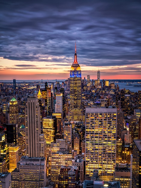 The sprawling New York City skyline viewed from a high vantage point during the twilight blue hour.