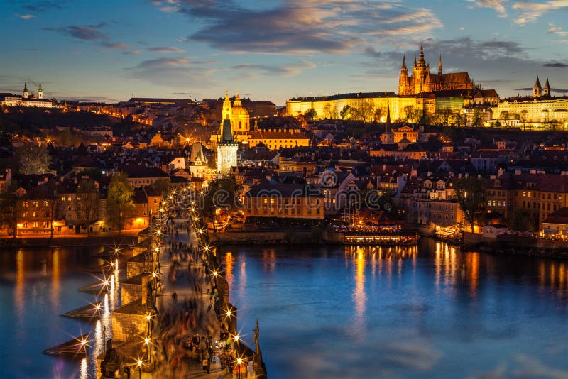 Prague Castle illuminated at night as seen from a river cruise on the Vltava