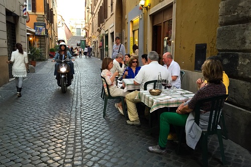 Outdoor seating area at a traditional Roman trattoria.