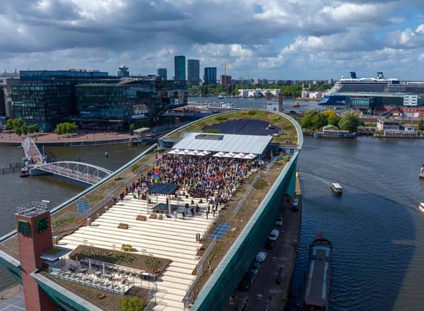 Panoramic view of Amsterdam skyline at sunset from the NEMO Science Museum rooftop terrace.
