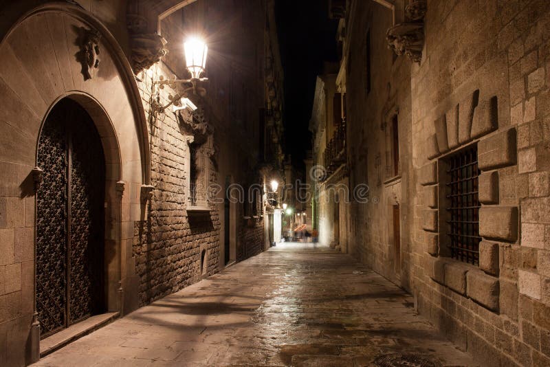 Narrow streets of the Gothic Quarter illuminated at night