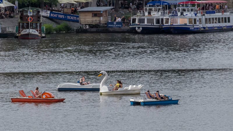 Tourists enjoying a Prague river cruise on a sunny day
