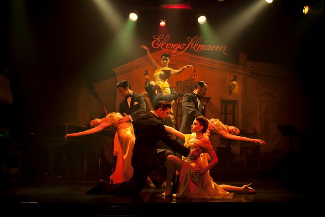 Professional tango dancers in elegant attire performing passionately on a Buenos Aires stage.