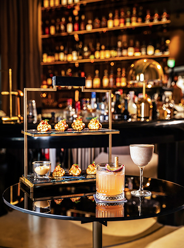 A stylish rooftop bar in Itaewon, Seoul, offering panoramic city views at night.