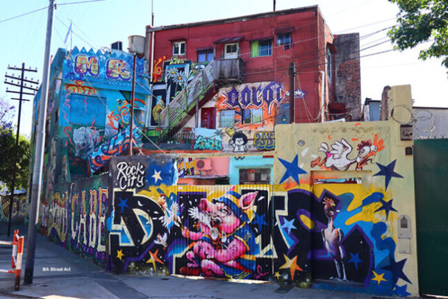 Vibrant and colorful street art adorning buildings in the La Boca neighborhood of Buenos Aires.