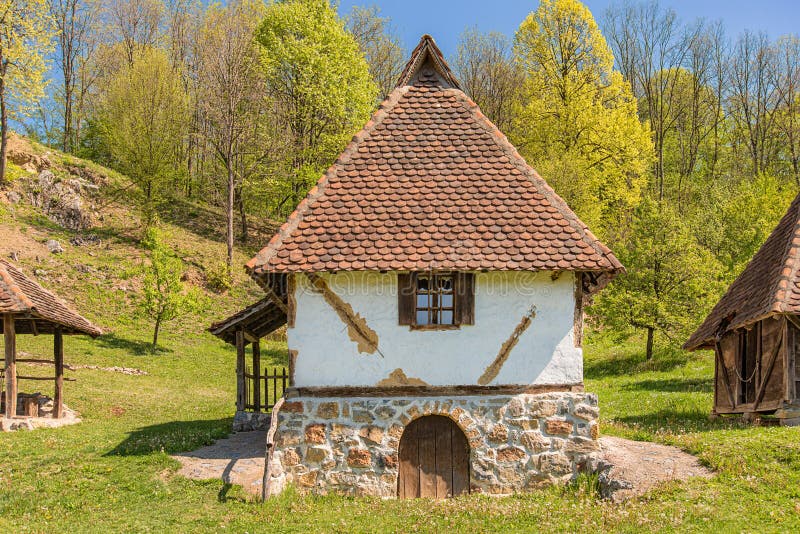 Charming traditional Serbian village houses with red roofs and wooden accents.